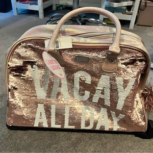 Justice carry on luggage with glowing 2 spinner wheels and handle.